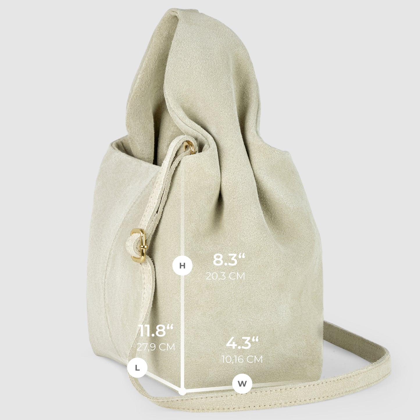 A soft, light beige handcrafted suede bag is shown upright with a long strap, showcasing Italian craftsmanship. Dimensions are marked: height 8.3 (20.3 cm), length 11.8 (27.9 cm), and width 4.3 (10.16 cm) on a light gray background.