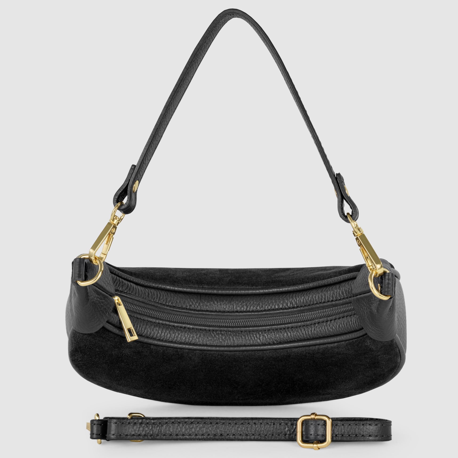 A black crescent handbag with gold hardware, featuring a curved shape, two zippered compartments, a short handle attached by gold clasps, and a detachable adjustable shoulder strap positioned in front of the bag.