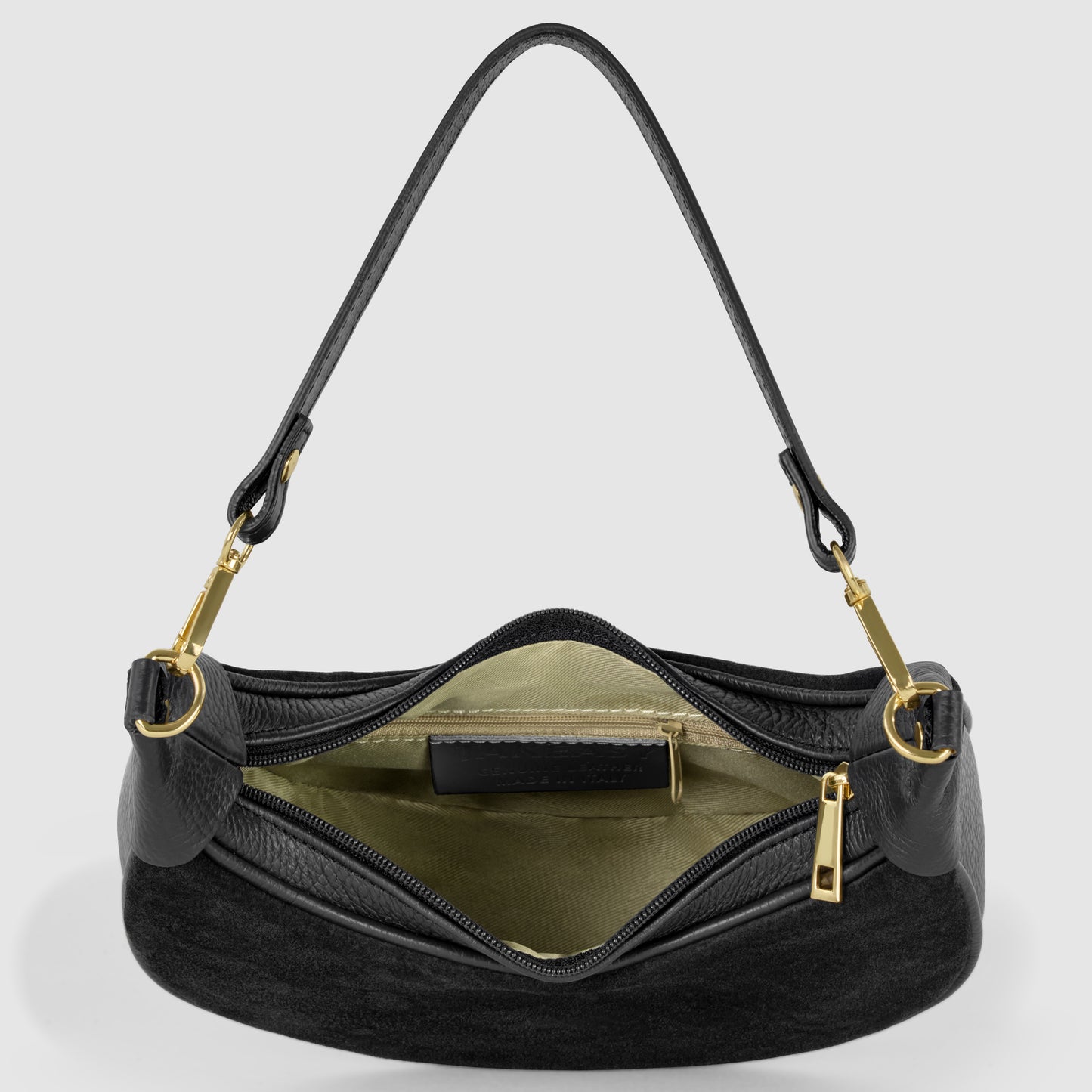 A black Italian leather bag with gold hardware, shown from above with the zipper open, reveals a light beige interior and an inner pocket. The detachable shoulder strap is attached to gold clasps on both sides.