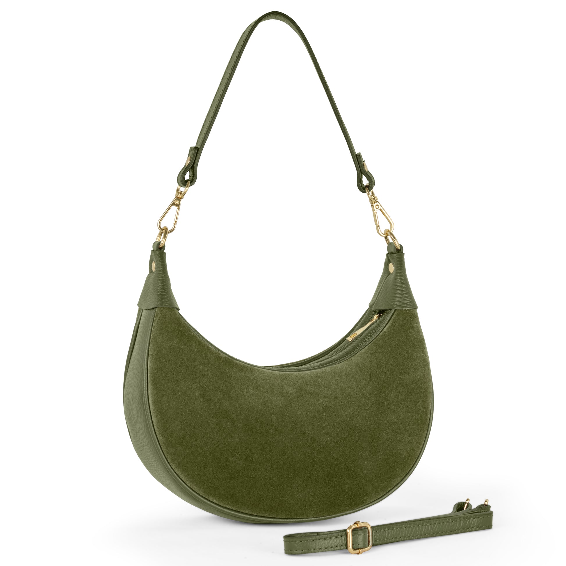 An olive suede crescent-shaped Italian leather bag with a short handle and gold hardware is displayed upright, while a matching adjustable shoulder strap lies in front of the handbag.