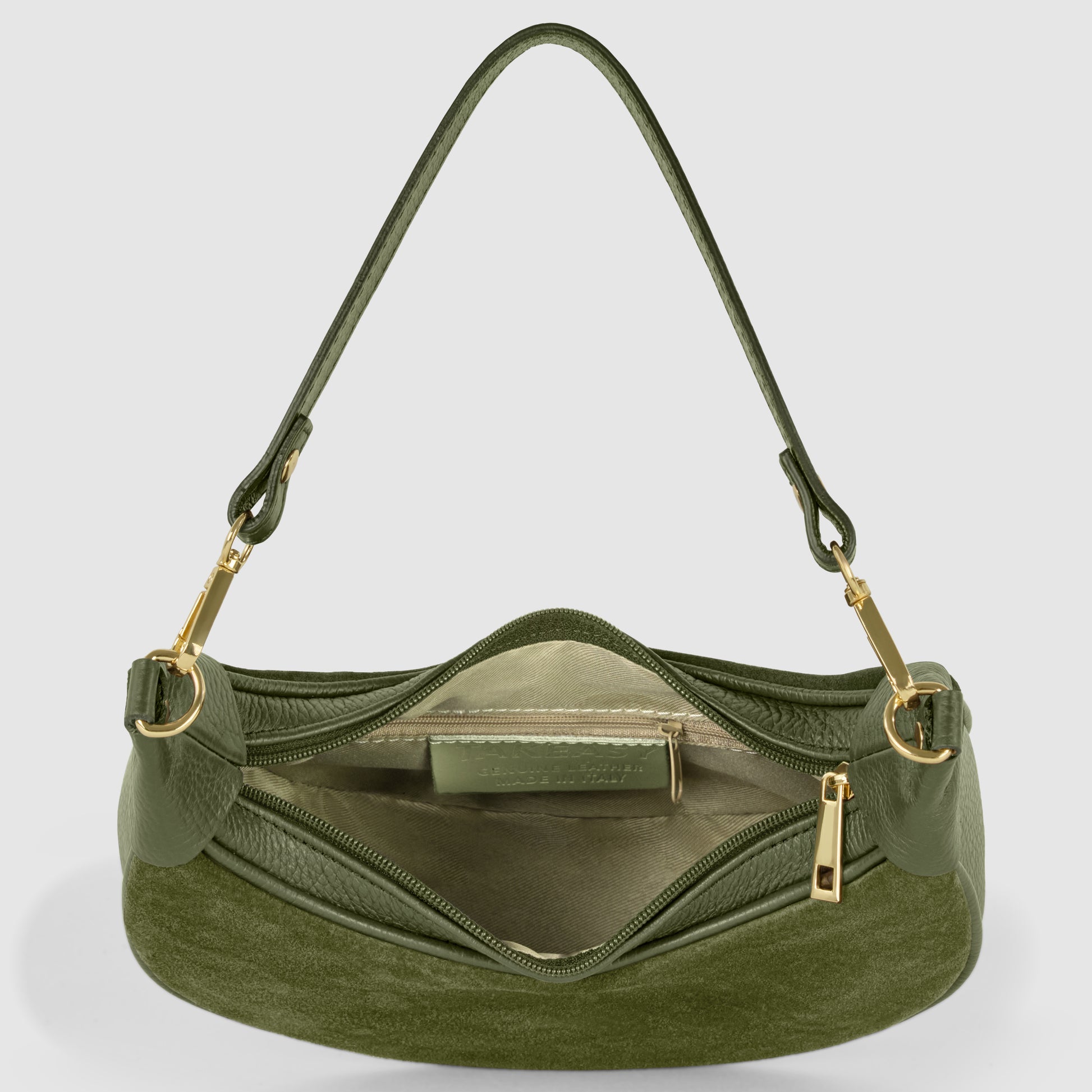 A green Italian leather bag with gold hardware is shown open, revealing a beige fabric interior, a zippered pocket, and an inner label. The handle is attached with gold clasps.