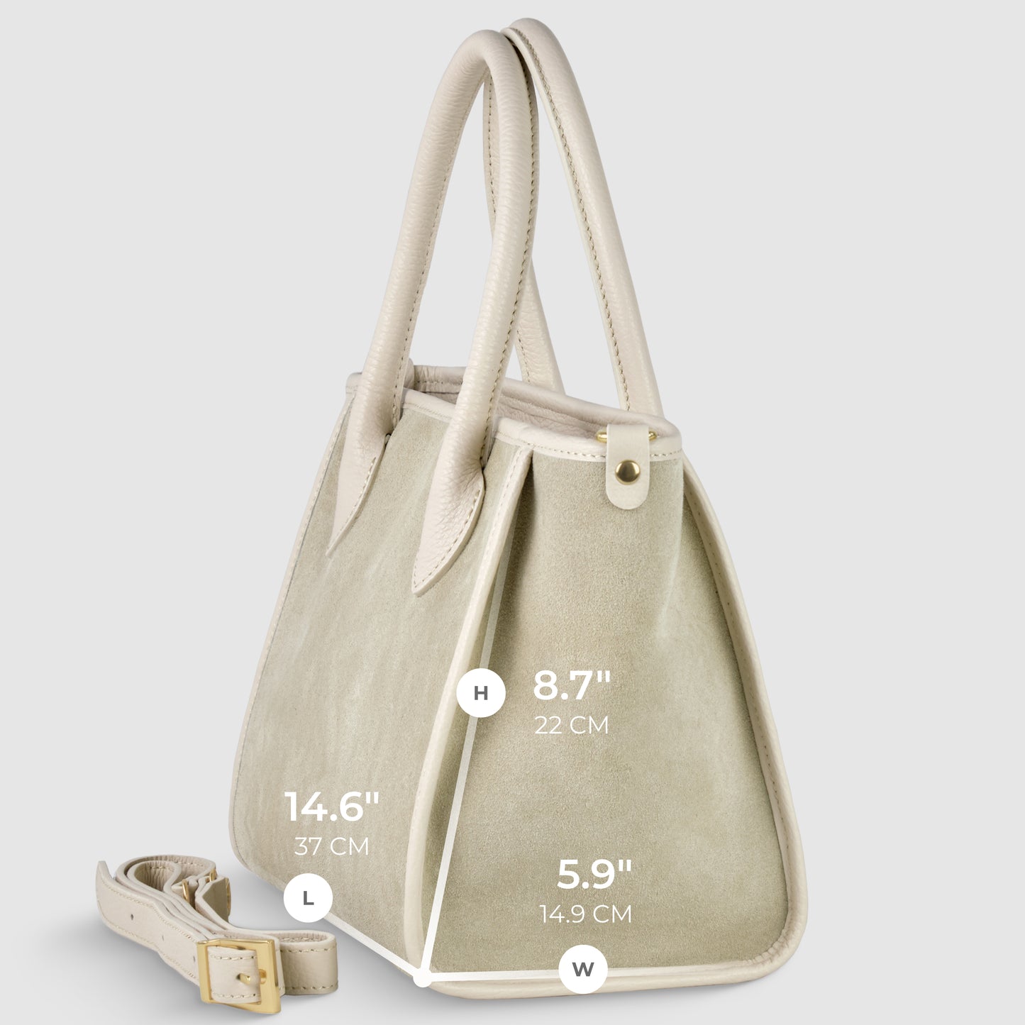A light beige Italian handcrafted suede leather handbag with off-white handles and trim, shown at an angle. An adjustable strap for crossbody carryall lies beside it. Dimensions: height 8.7 (22 cm), length 14.6 (37 cm), width 5.9 (14.9 cm).