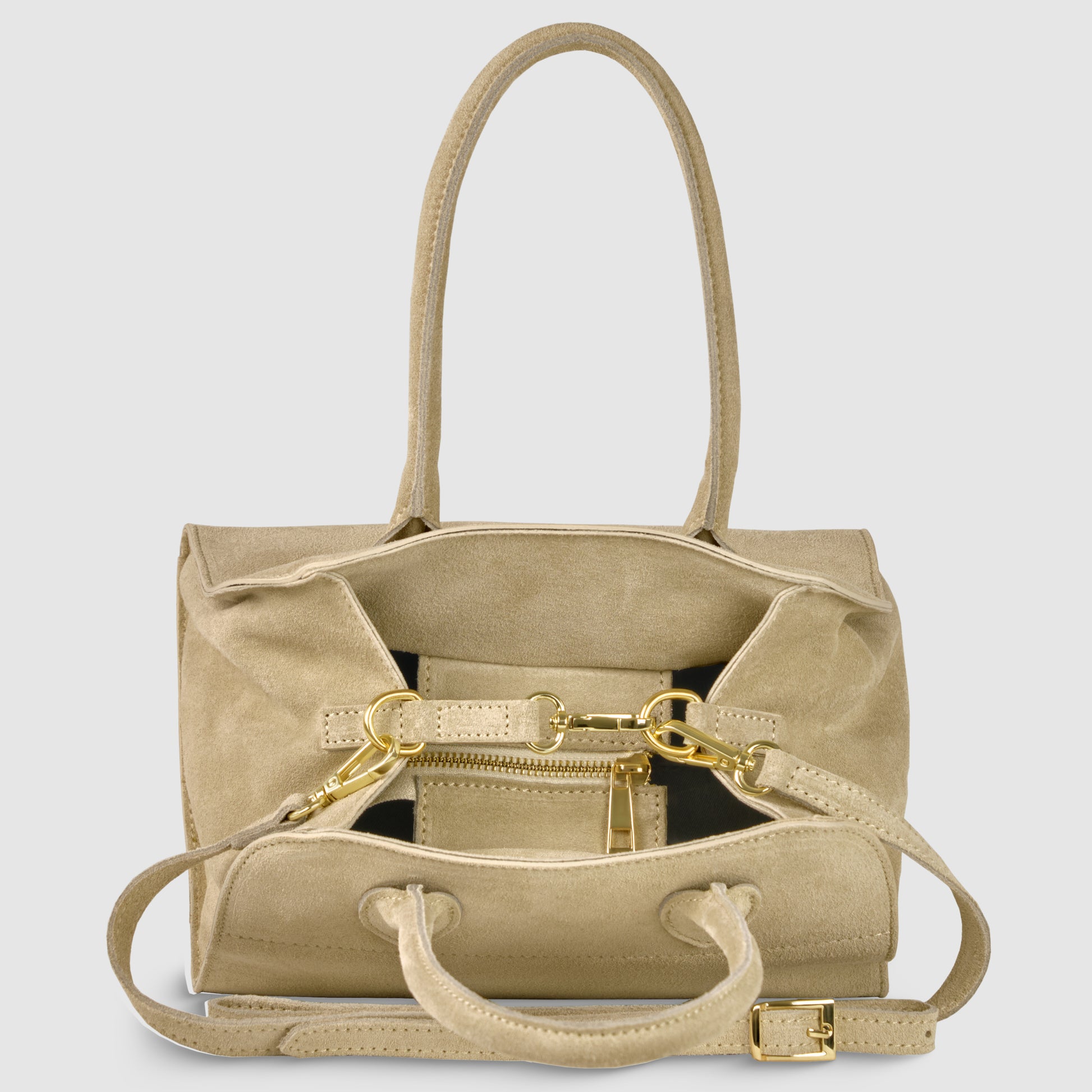 A beige handmade Italian handbag in genuine suede with gold hardware, double top handles, and a detachable shoulder strap. The open main compartment reveals a zippered pocket and a matching small pouch inside.