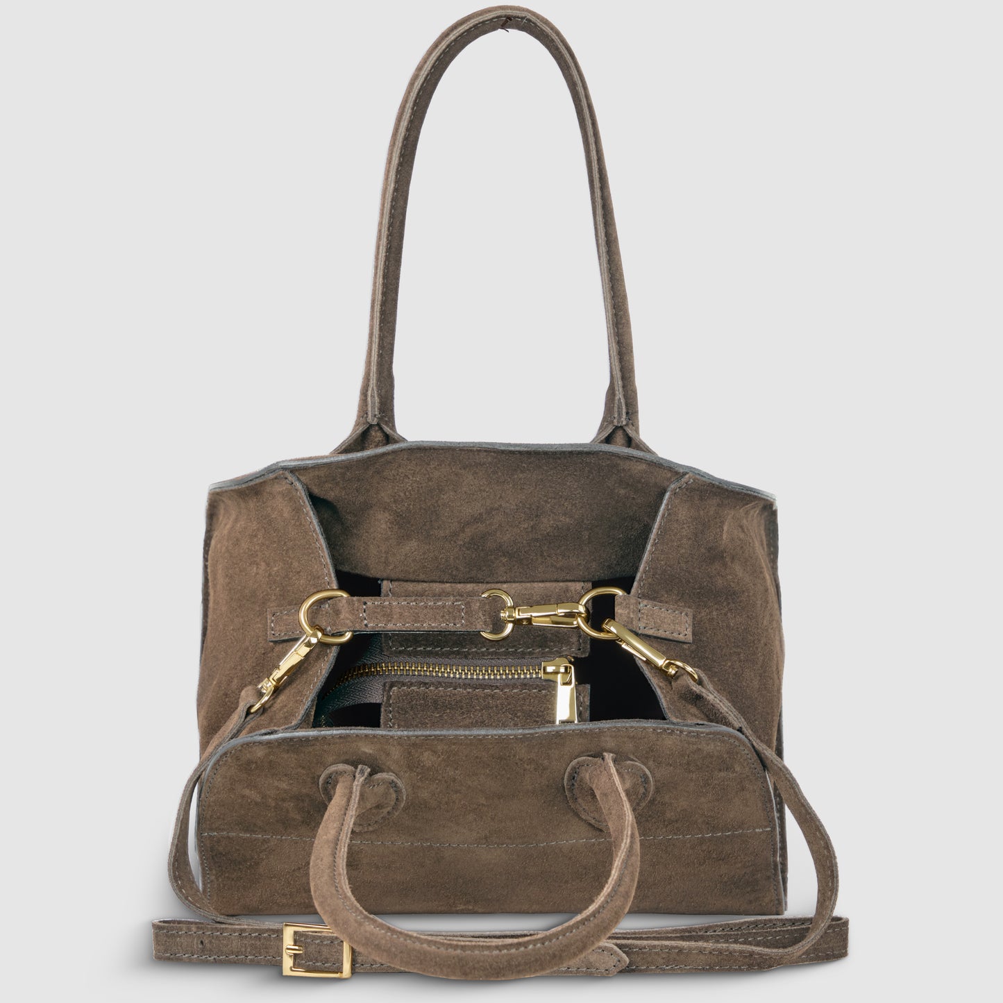 A luxury Italian handbag in brown genuine suede with two handles, a shoulder strap, and gold hardware. The open bag reveals a zippered pouch and wallet inside, set against a light gray background.