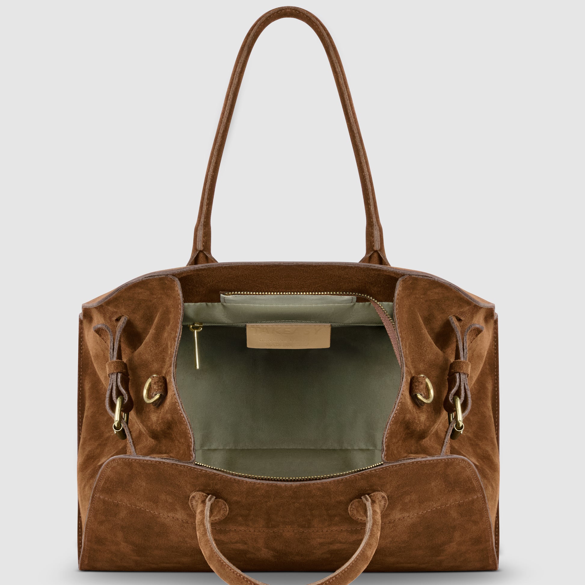 A brown Italian suede purse with two handles is shown open, revealing a spacious light gray interior, a zippered pocket, and a gold zipper pull. The bag features gold hardware and side drawstring details.
