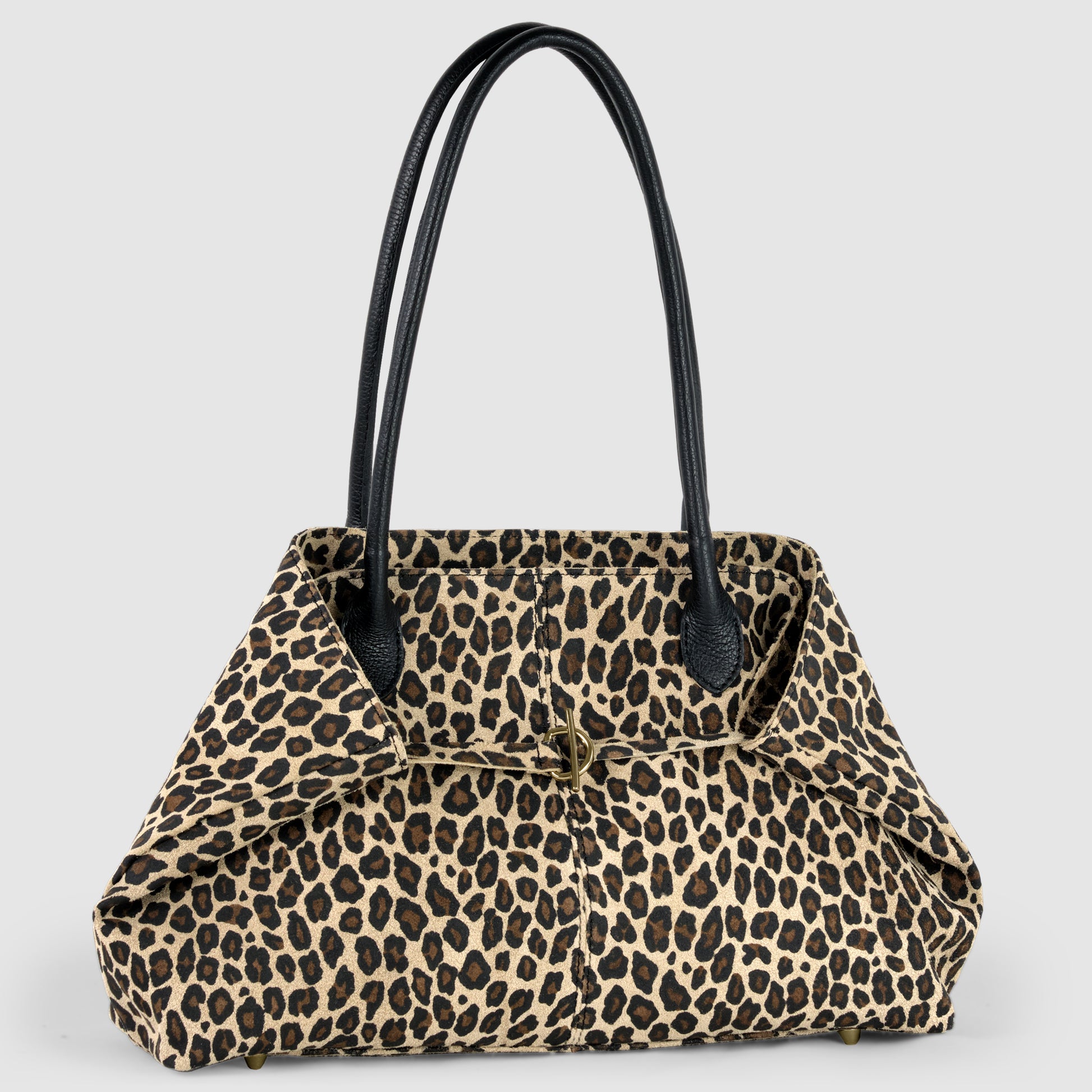 A stylish Italian-crafted tote with a leopard print pattern, featuring black handles and metal studs on the bottom, set against a plain light gray background.