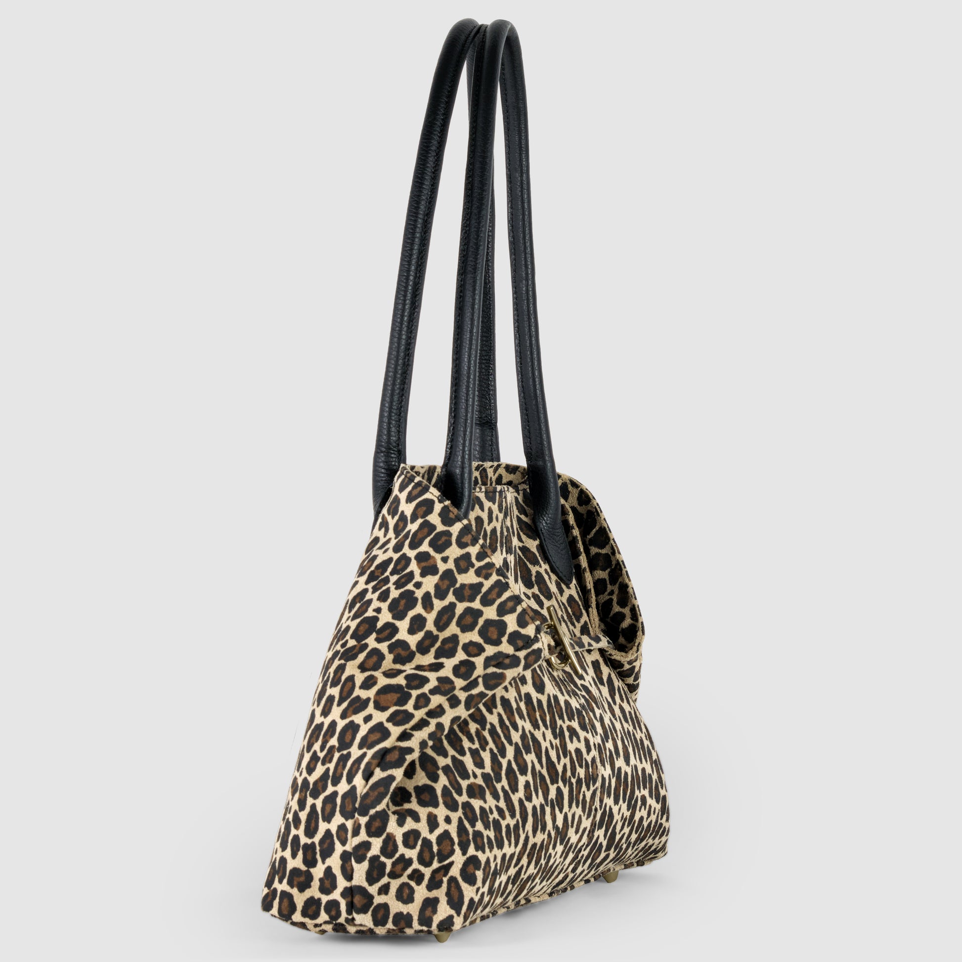 A leopard print Italian-crafted tote with long black handles, displayed at an angle on a plain light gray background.