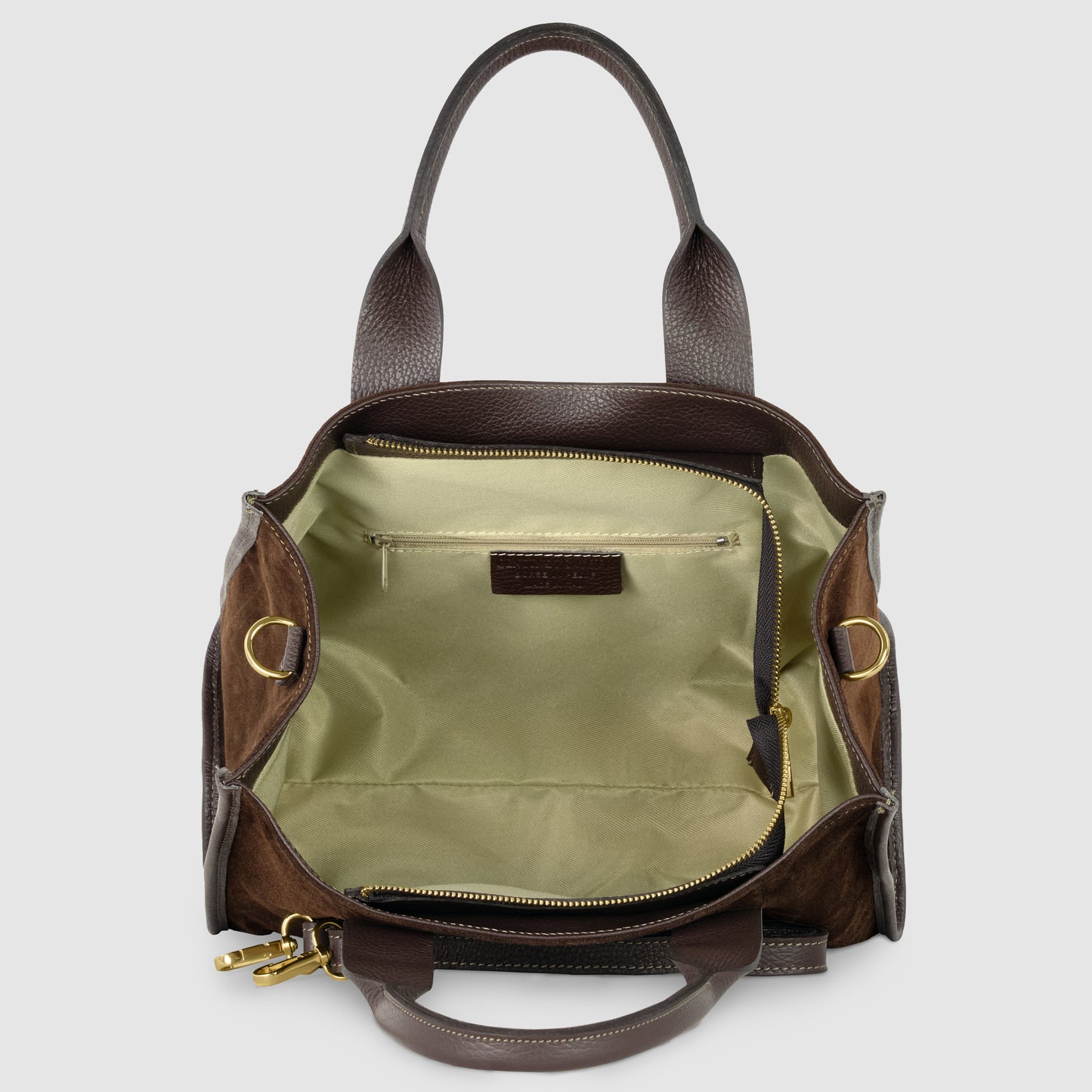 A brown suede crossbody leather bag with gold hardware shown open, revealing a light green fabric interior, an inner zipper pocket, and two open compartments.