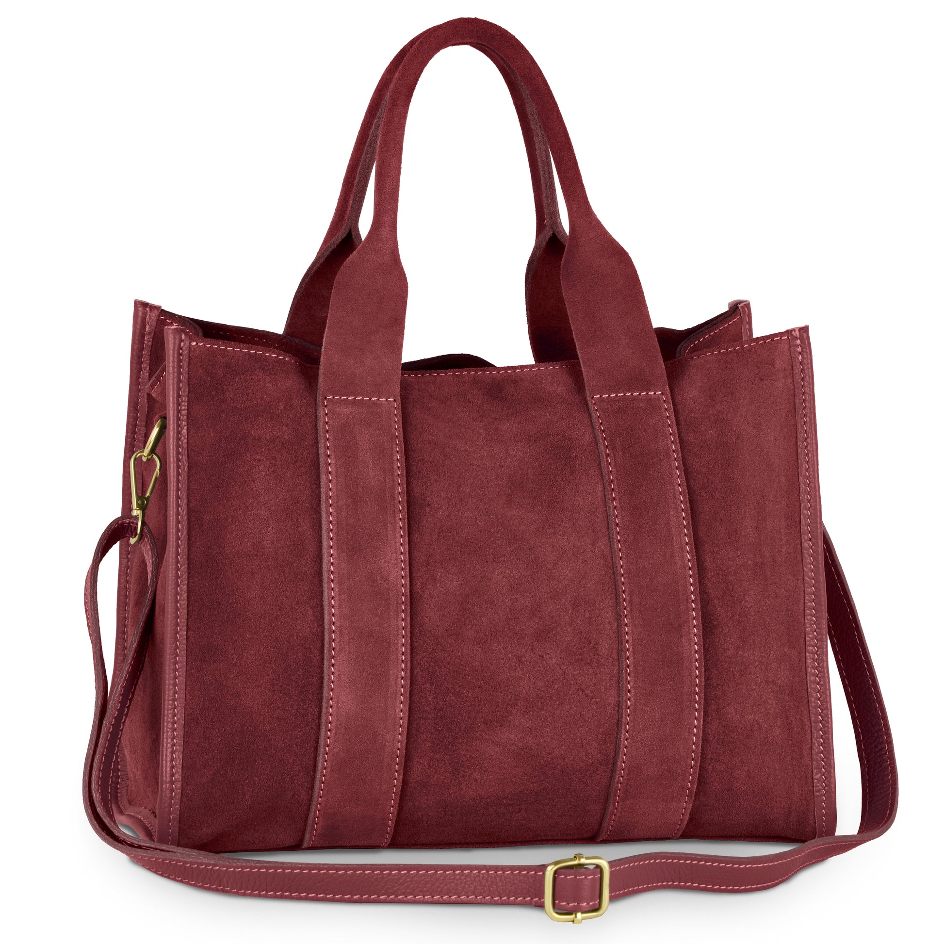 A spacious, rectangular handmade bag in burgundy suede with two short handles, a long adjustable shoulder strap, visible stitching, and gold-tone hardware.
