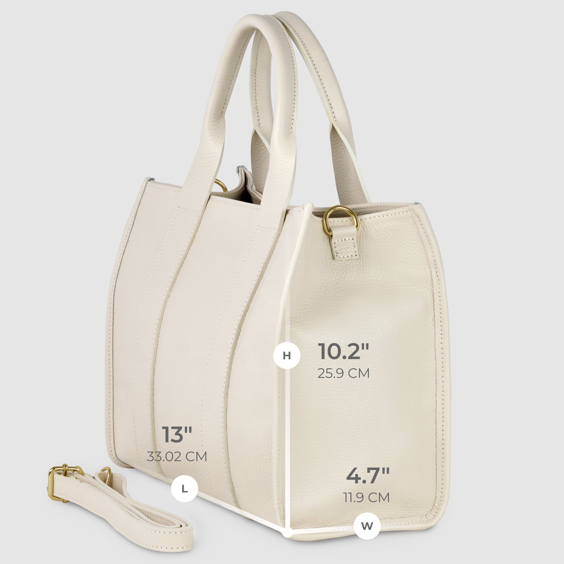 A cream-colored Italian leather handbag with dual handles and a detachable strap. This handcrafted handbag measures 13" long, 10.2" high, and 4.7" wide with gold-tone hardware. Dimensions are labeled in inches and centimeters.