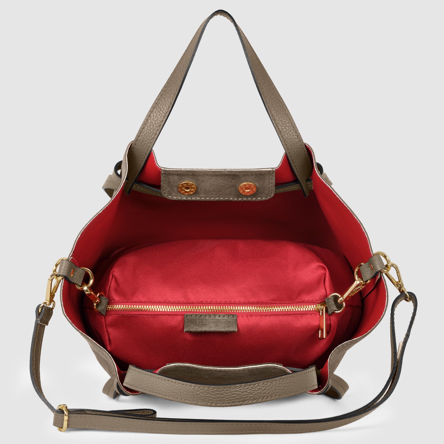 A taupe leather handbag crafted with exquisite Florentine leatherwork, featuring a red interior, gold hardware, and a matching detachable shoulder strap. The open bag reveals a red zippered pouch inside.