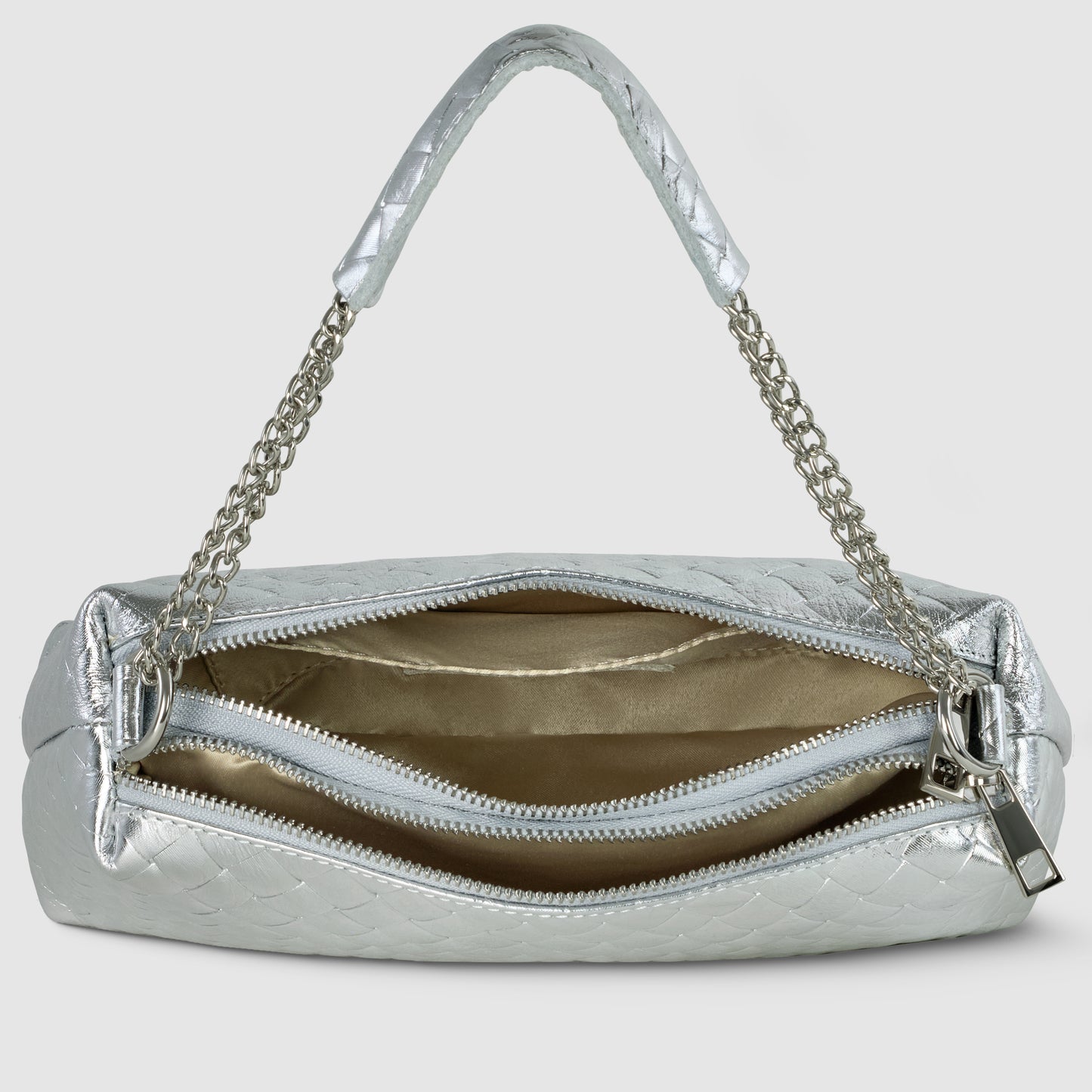 A silver miniature handbag with a quilted texture, metallic chain straps, and an open zipper reveals a spacious, gold-lined interior with two compartments—showcasing refined Italian craftsmanship.