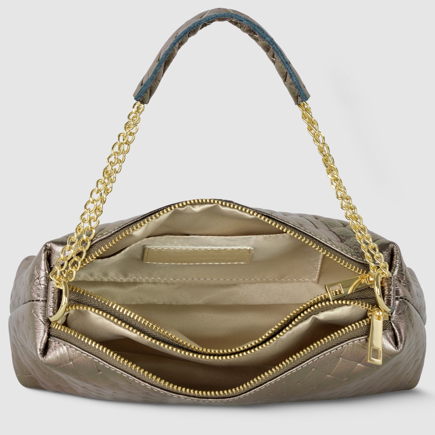 A metallic gold miniature handbag with a gold chain handle is shown open, revealing Italian craftsmanship with a beige fabric interior, two zippered compartments, and a small pocket inside.