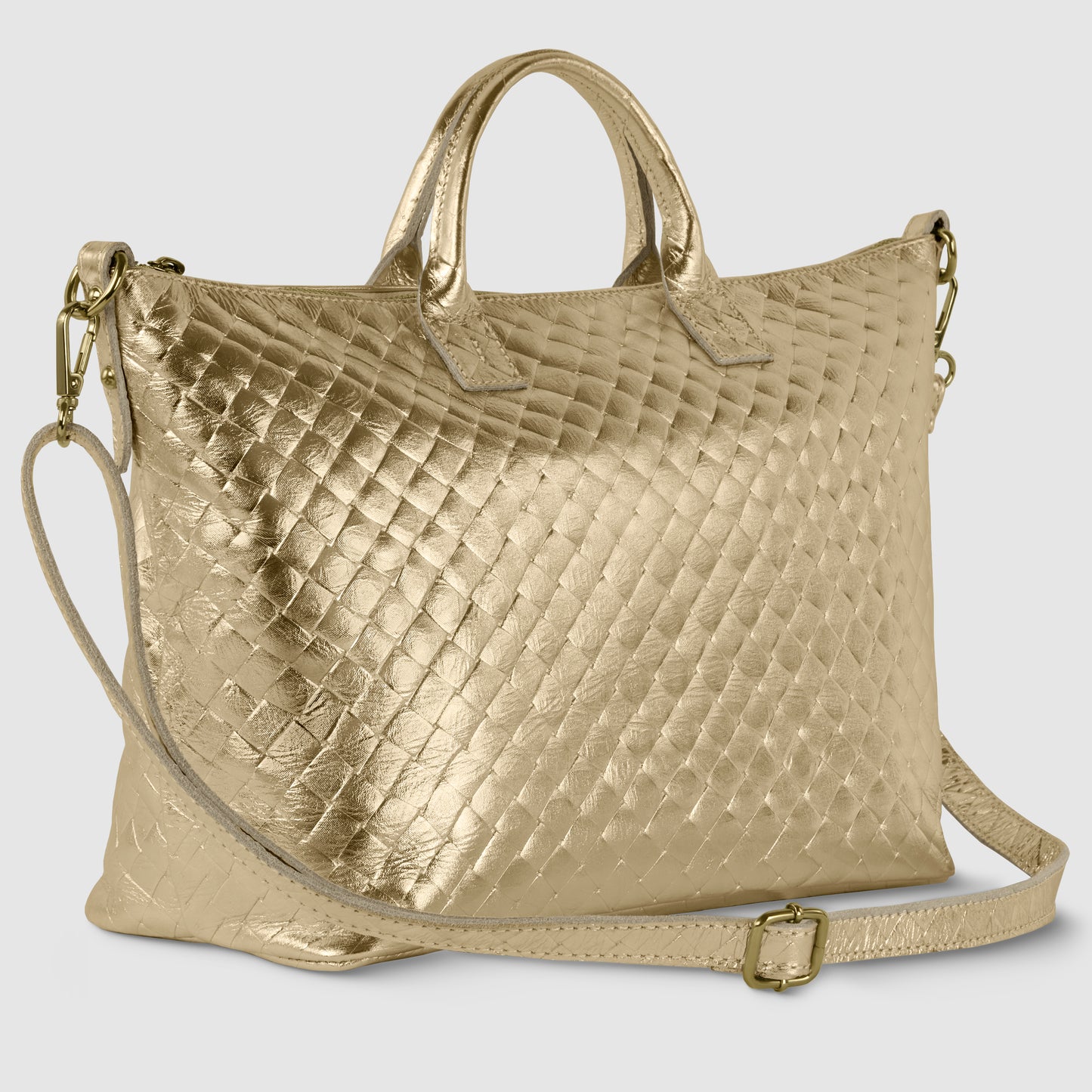 A gold, textured leather handbag inspired by Florentine leathercraft, featuring two short handles and a long, adjustable shoulder strap, displayed on a light gray background.