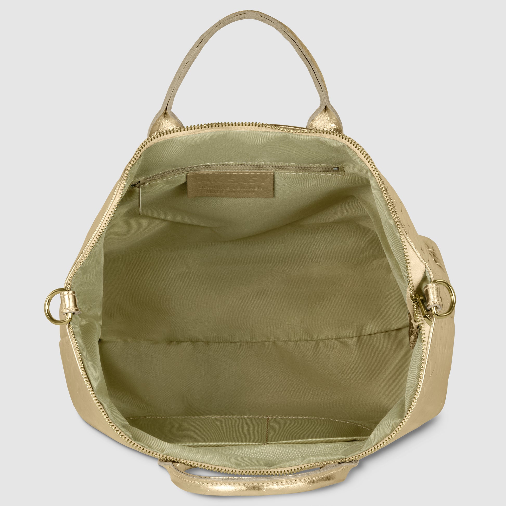Open gold handcrafted Italian handbag showing light olive green fabric interior with a zippered pocket on the back wall, gold hardware, and two handles visible at the top.