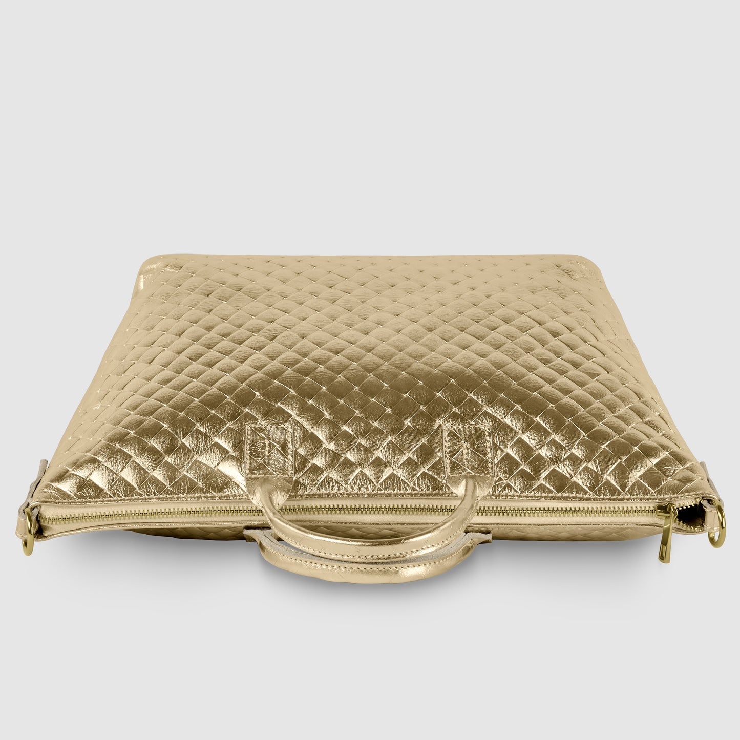 A gold, quilted laptop bag inspired by handcrafted Italian handbag design, featuring two handles and a zipper, displayed against a plain white background.