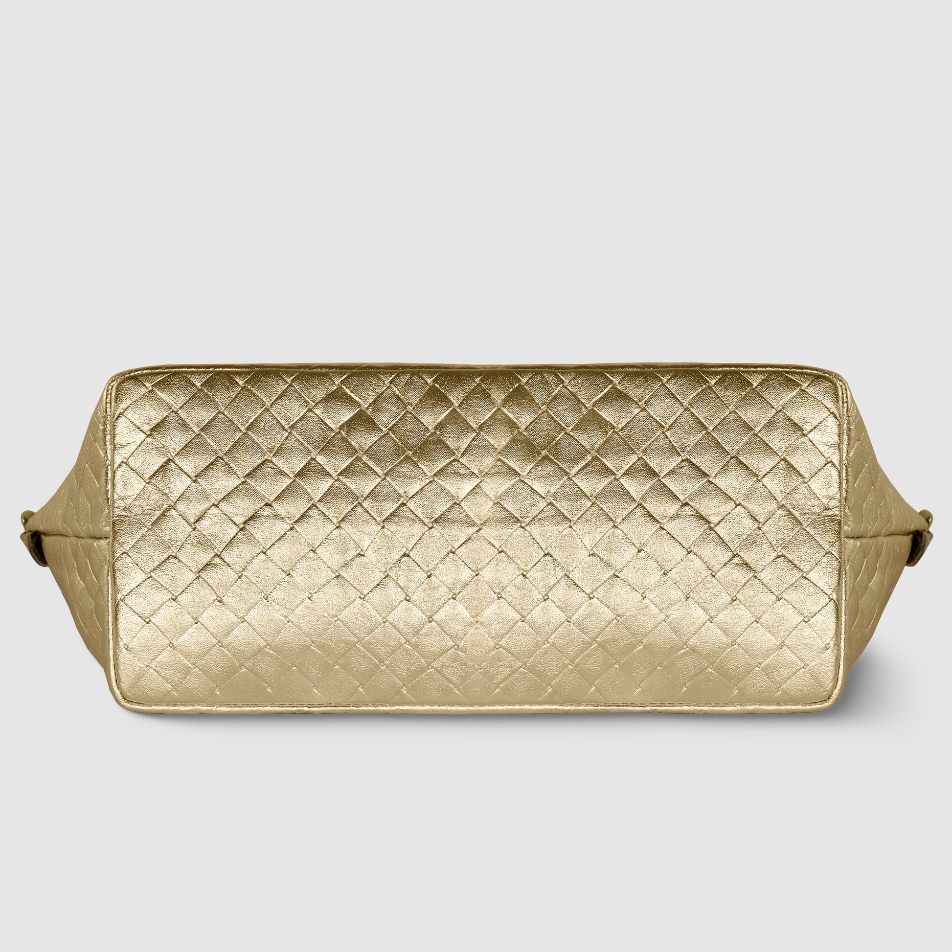 A rectangular gold quilted leather bag, inspired by Florentine leathercraft, is shown from the bottom, displaying a diamond-patterned texture with side edges slightly visible against a plain light background.