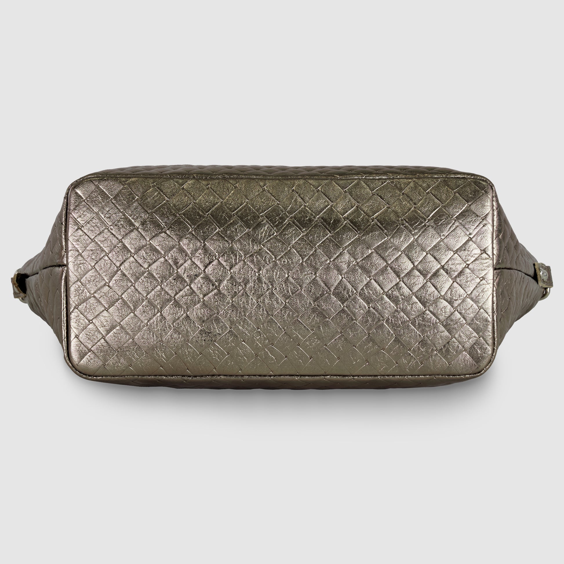 Rectangular, metallic bronze handcrafted Italian handbag with a woven, textured pattern shown from the bottom view, against a plain light background.