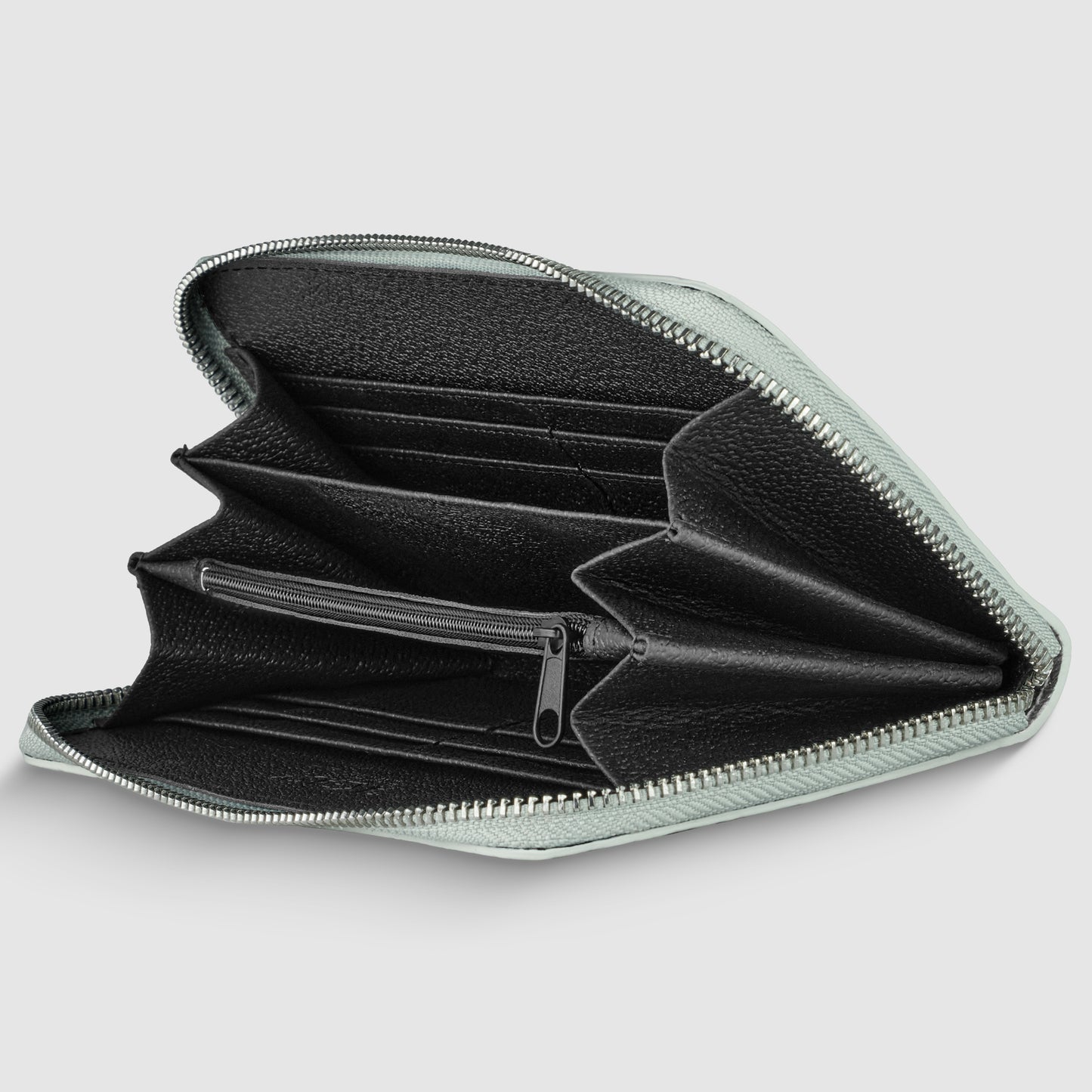 A zippered black Italian leather wallet is open, showing multiple compartments for cards, cash, and a central zippered pocket for coins against a plain light gray background.