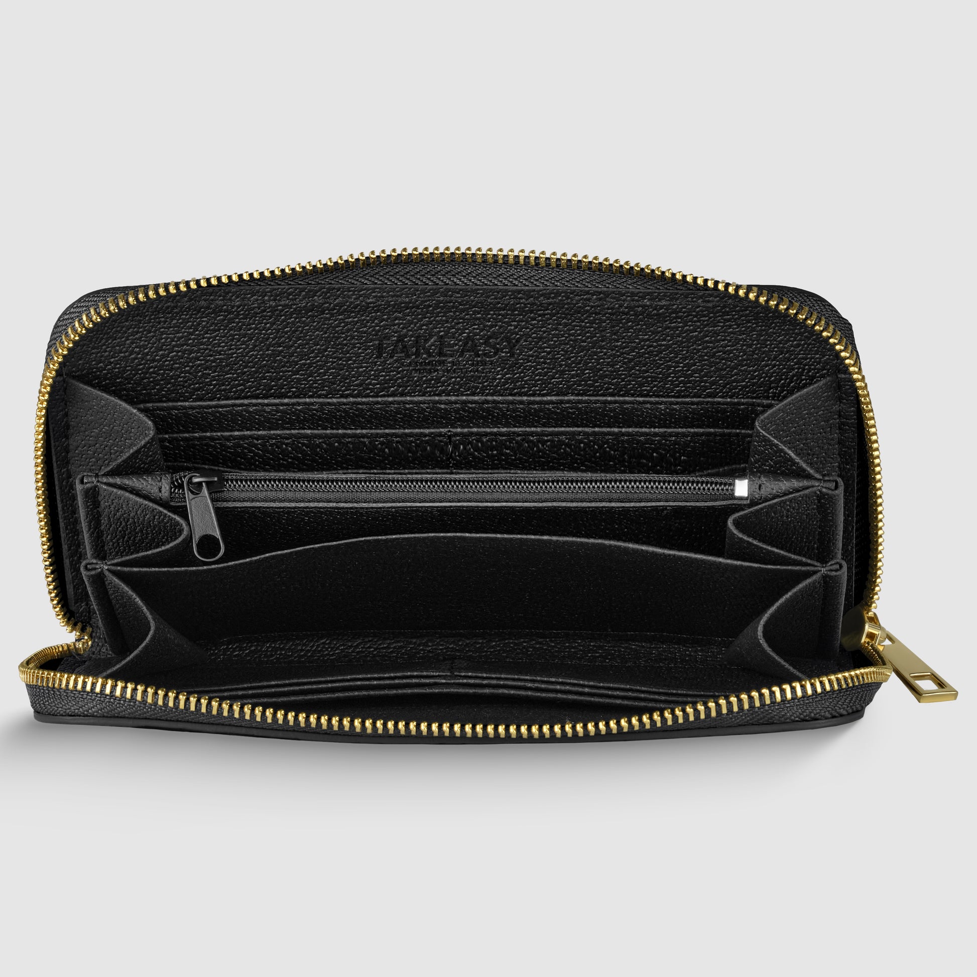 Black leather zippered wallet, handcrafted in Italy, open to show multiple compartments, card slots, and a central zippered pocket with gold zipper hardware against a plain light background.